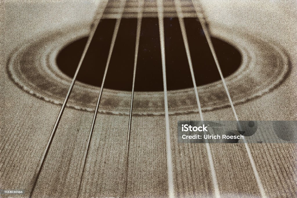 Music A concert guitar in sepia. Awe Stock Photo
