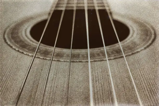 A concert guitar in sepia.