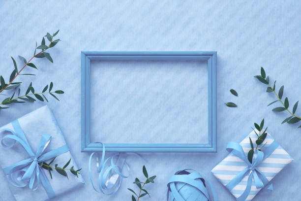 istock Flat lay in light blue hues with wrapped gift boxes decorated with eucalyptus twigs 1133030550