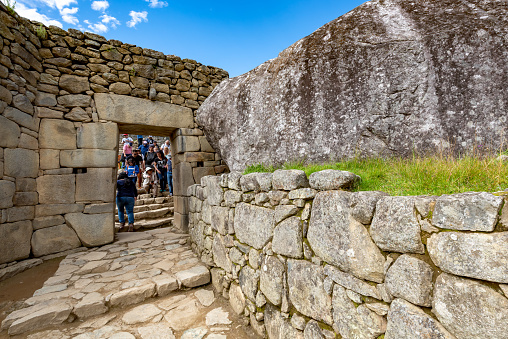 Cusco, Peru - Oct 16, 2018: Machu Picchu aerial view. Tourists are walking through the old abandoned city.