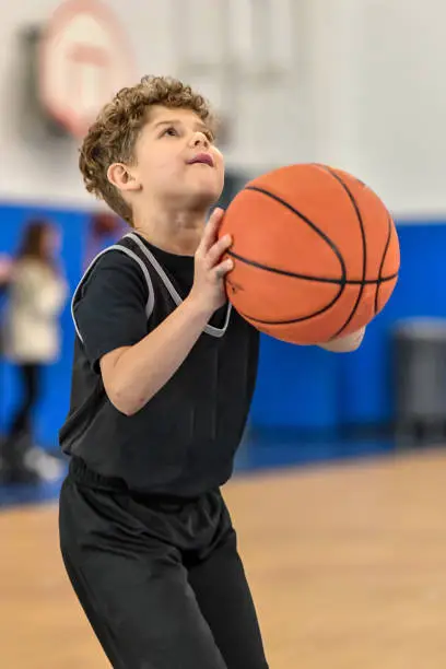 Photo of Little boy playing basketball
