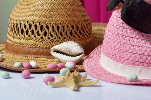 istock Accessories for summer holidays. Sun hats, seashells, sunglasses, colored pebbles and starfish on a white background. 1133034113