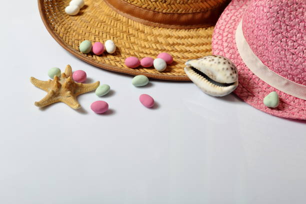 istock Accessories for summer holidays. Sun hats, seashells colored pebbles and starfish on a white background. 1133034116