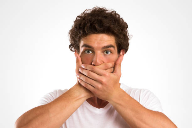 istock Young Man Covering His Mouth 1133034719
