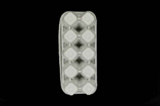 istock Cardboard empty tray for ten pieces eggs isolated on black background 1133035540