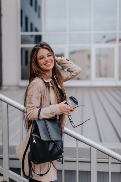 istock Business woman smiling and holding coffee 1133035564