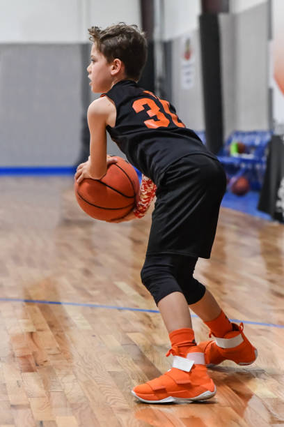 istock Young boy playing basketball 1133037219