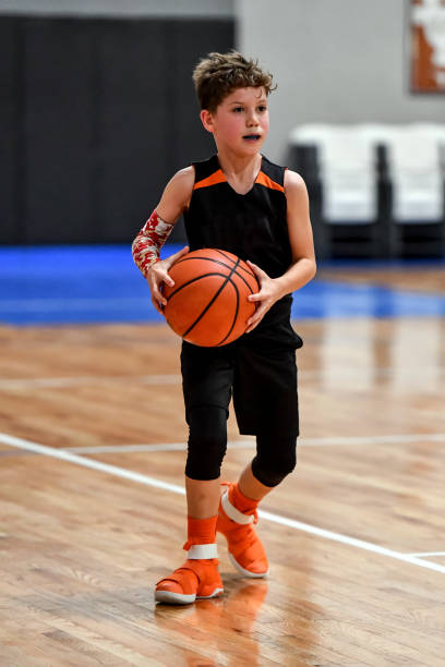 istock Young boy playing basketball 1133037249