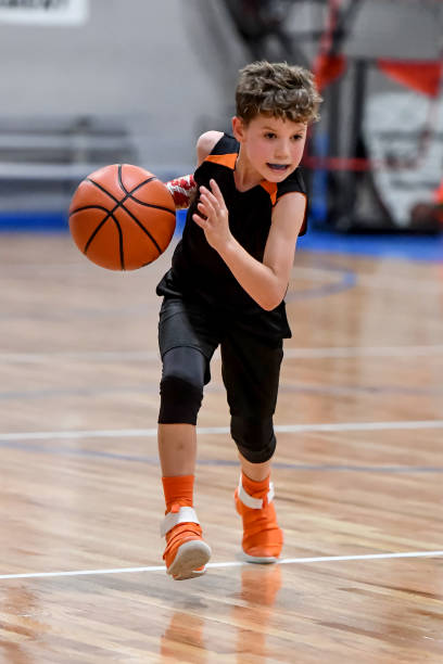 istock Young boy playing basketball 1133037401