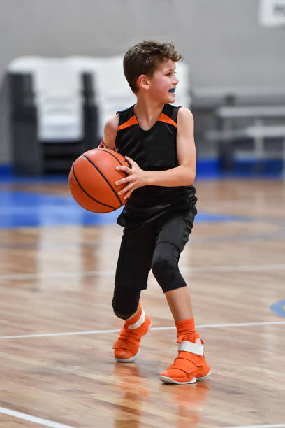 istock Young boy playing basketball 1133037405