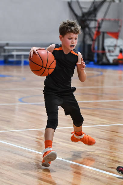 istock Young boy playing basketball 1133037427