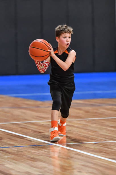 istock Young boy playing basketball 1133037440