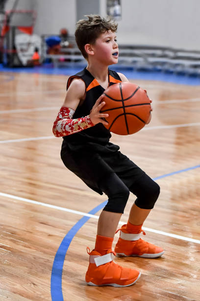 istock Young boy playing basketball 1133037454