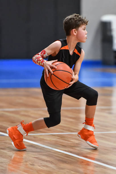istock Young boy playing basketball 1133037462