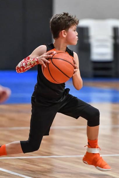 istock Young boy playing basketball 1133037470