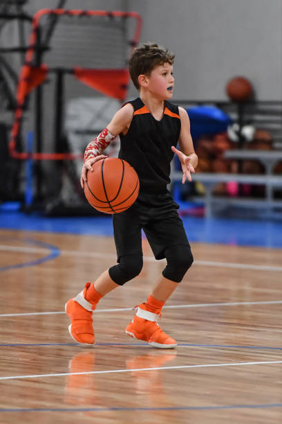 istock Young boy playing basketball 1133037474