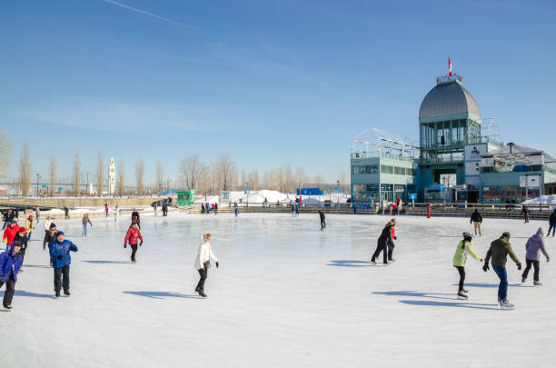 People Skating in Quebec City Town Square looking towards Palais Montcalm on a cold February day.