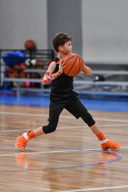 istock Young boy playing basketball 1133037503