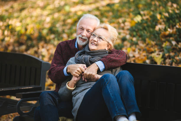 istock Happy autumn senior couple on park bench 1133037547