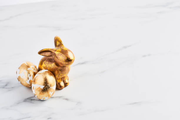 istock Easter greeting card, golden rabbit and eggs decorated with golden foil 1133037577