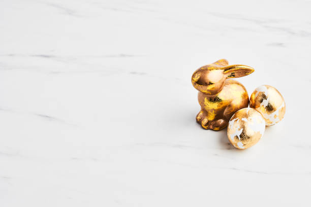 istock Easter greeting card, golden rabbit and eggs decorated with golden foil 1133037589