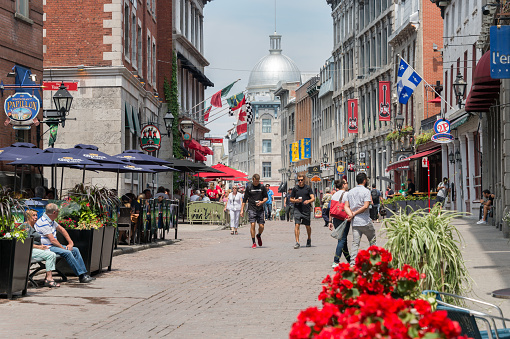Montreal, CANADA - 12 June 2017: Tourists walking on St Paul Street and visiting Old Montreal in Summer.