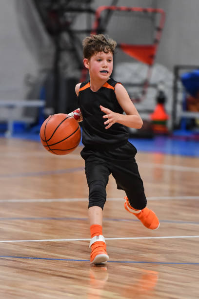 istock Young boy playing basketball 1133037642