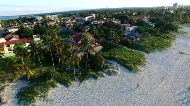 Drone is flying over tropical island in the Atlantic Ocean. Bird's-eye view to main streets, houses and coastline of Varadero.