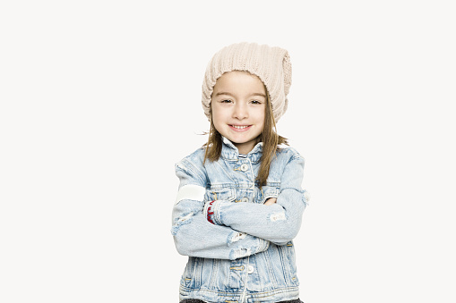 Young girl looking at camera with happy facial expression over white background