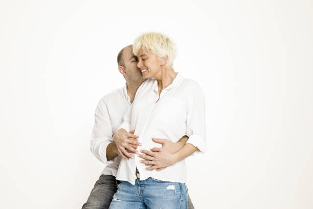 istock Pregnant woman with her husband over white background 1133039603