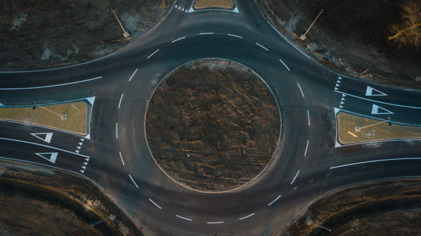 istock Cars are moving through a newly built traffic circle 1133040247