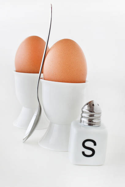 istock Two brown eggs with salt and salt shaker 1133041878