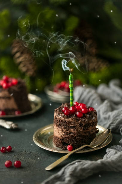 istock Celebratory chocolate cake with an extinct candle of green 1133043082