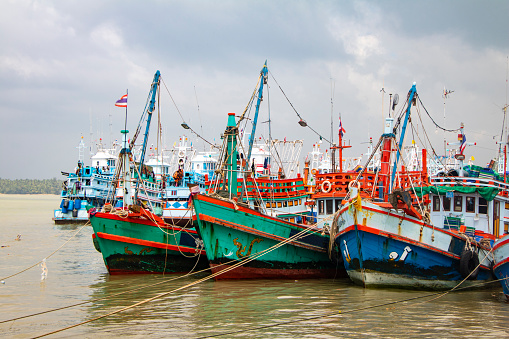 Colorful fishing boats in the harbor, Thailand. Sailing concept.