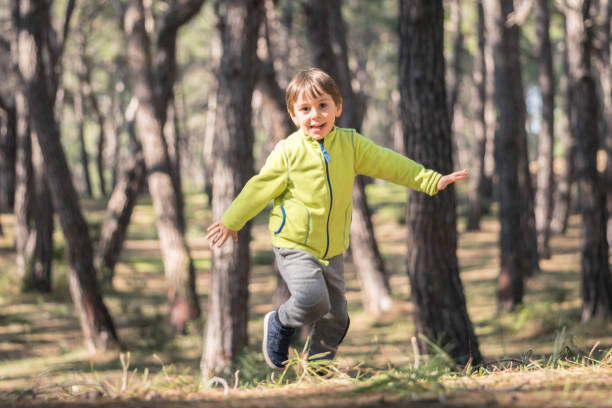 istock Happy little boy running in forest 1133044490