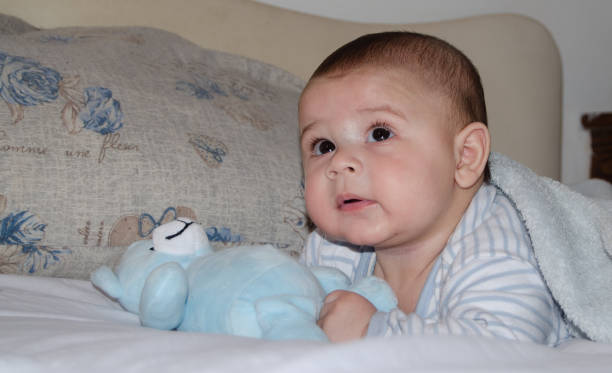 istock cute 4 months old baby boy having tummy time and making funny faces 1133044538