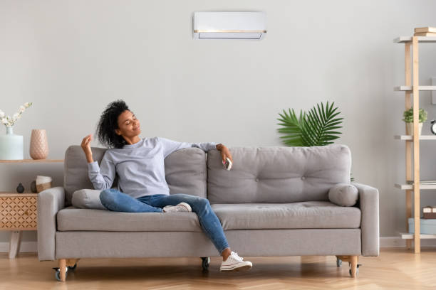 african young relaxed woman sitting on couch breathing fresh air - african descent american culture exercising women imagens e fotografias de stock