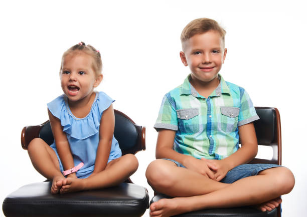 istock Brother and sister having fun over gray background 1133047351