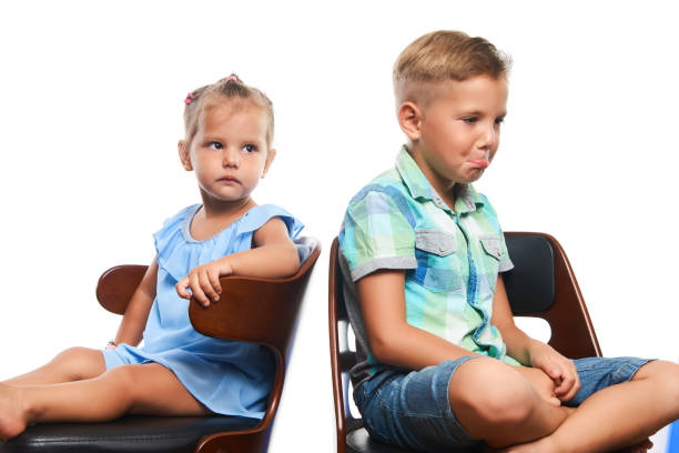istock Brother and sister having fun over gray background 1133047358