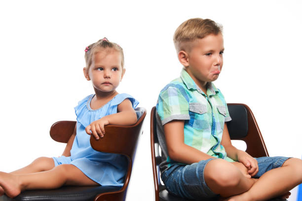 istock Brother and sister having fun over gray background 1133047360