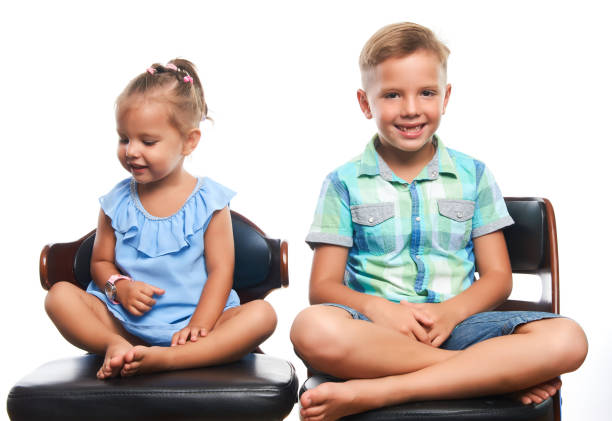 istock Brother and sister having fun over gray background 1133047387