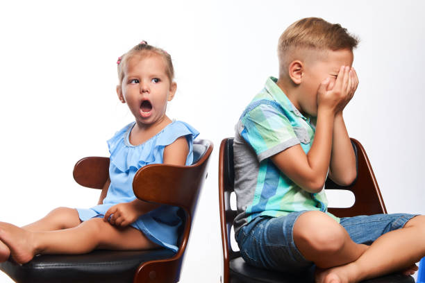 istock Brother and sister having fun over gray background 1133047396