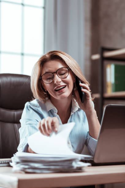 istock Blonde-haired businesswoman searching some important work documents 1133047638
