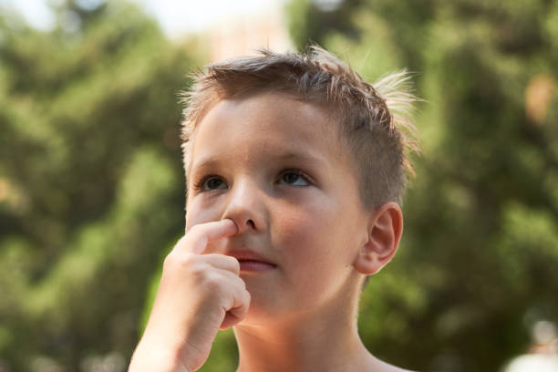 istock ute little boy enjoying picking his nose, close-up. 1133047694