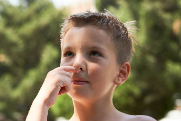 istock ute little boy enjoying picking his nose, close-up. 1133047696