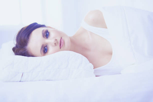istock Young beautiful woman lying in bed. 1133051396