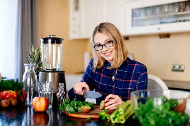 istock Woman cutting kiwi fruit in kitchen. 1133053297