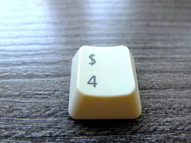 istock Keyboard key with dollar sign and number four. Making money in the internet using computer technologies. Close-up. 1133053575