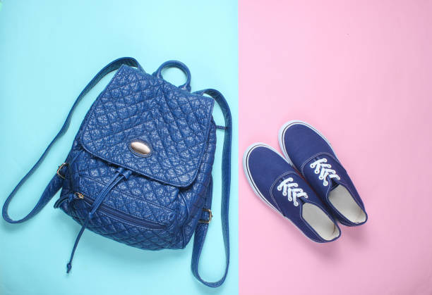 istock Leather fashionable backpack, sneakers on pastel background. Top view. Minimalism 1133054504