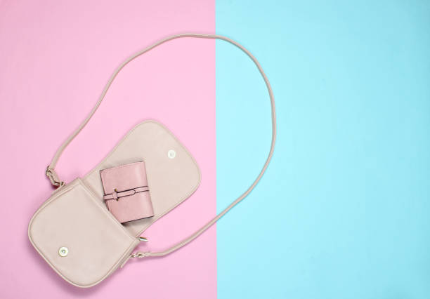 istock Open stylish leather bag with a purse on a pastel background. Top view, minimalism. 1133055758